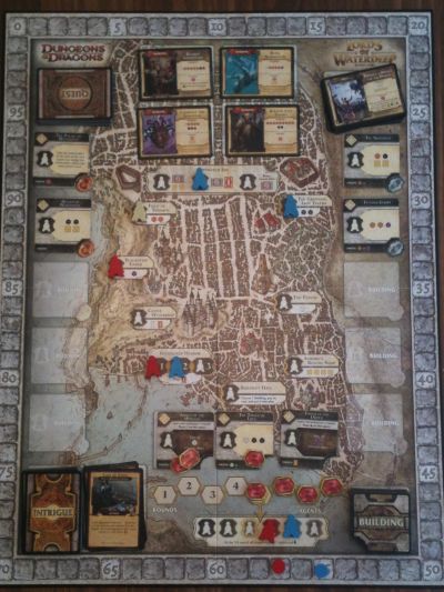 The board acts as the city of Waterdeep, clearly outlining which cards and tokens go where.